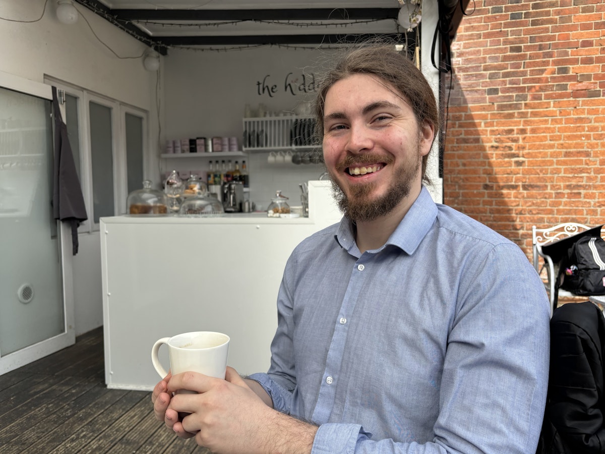 Adam Littler sitting in a cafe